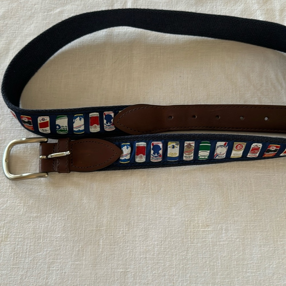 Men’s belt by “The Belted Cow Co” Navy blue and has different beer can prints
